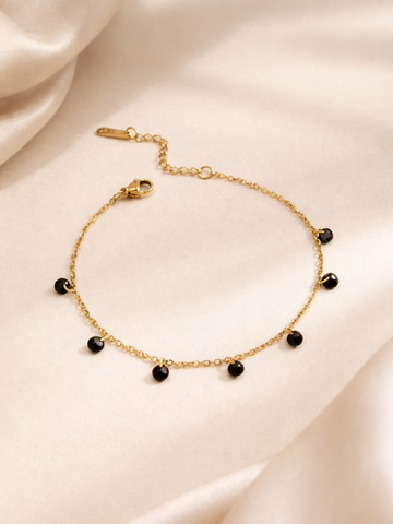 Gold bracelet with black beads