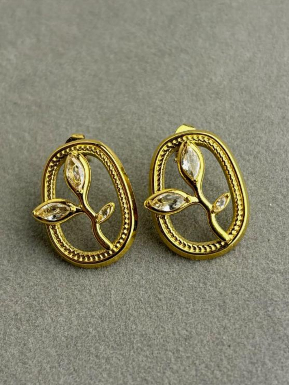 Pair of gold earrings with leaf design