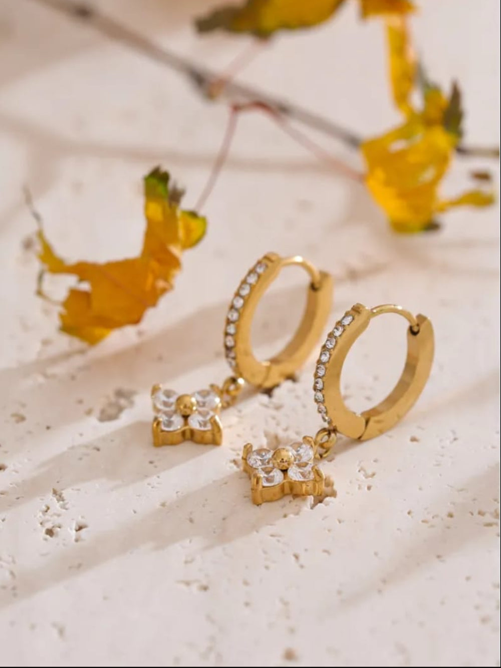Gold hoop earrings with small diamond-like stoNES