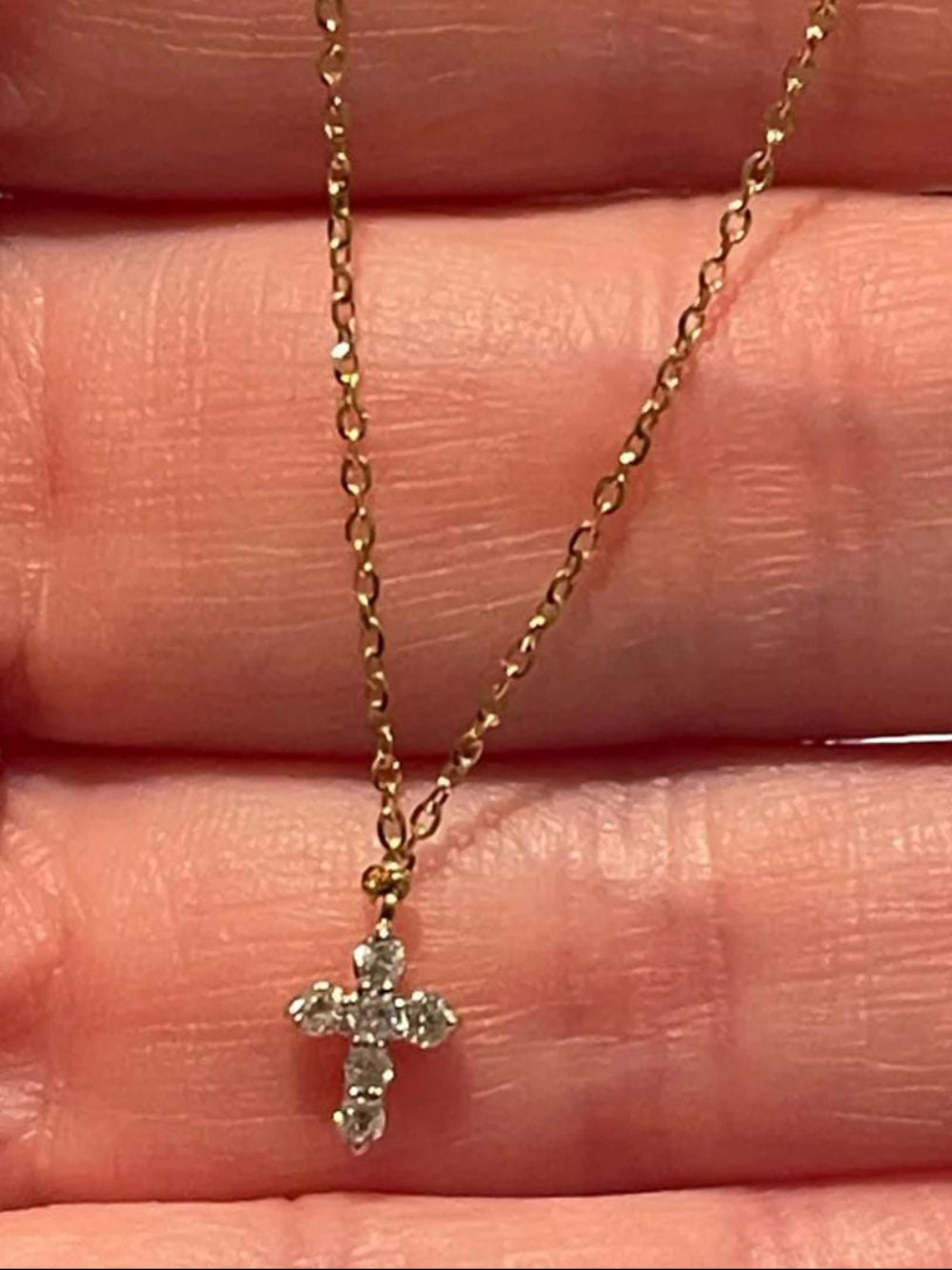 Gold necklace with a cross pendant