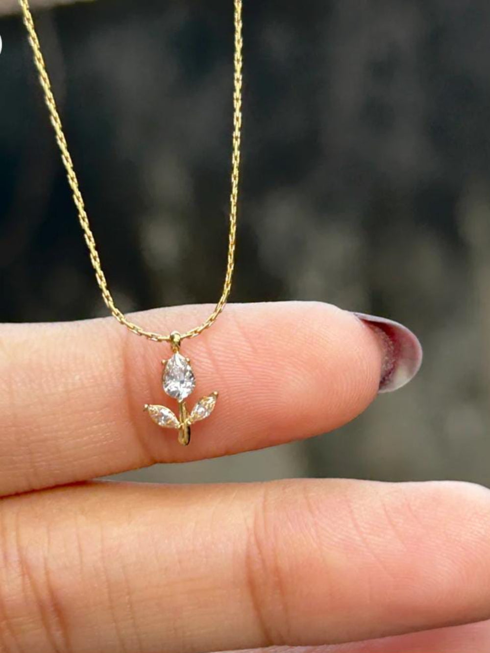 Gold necklace with a leaf-shaped pendant