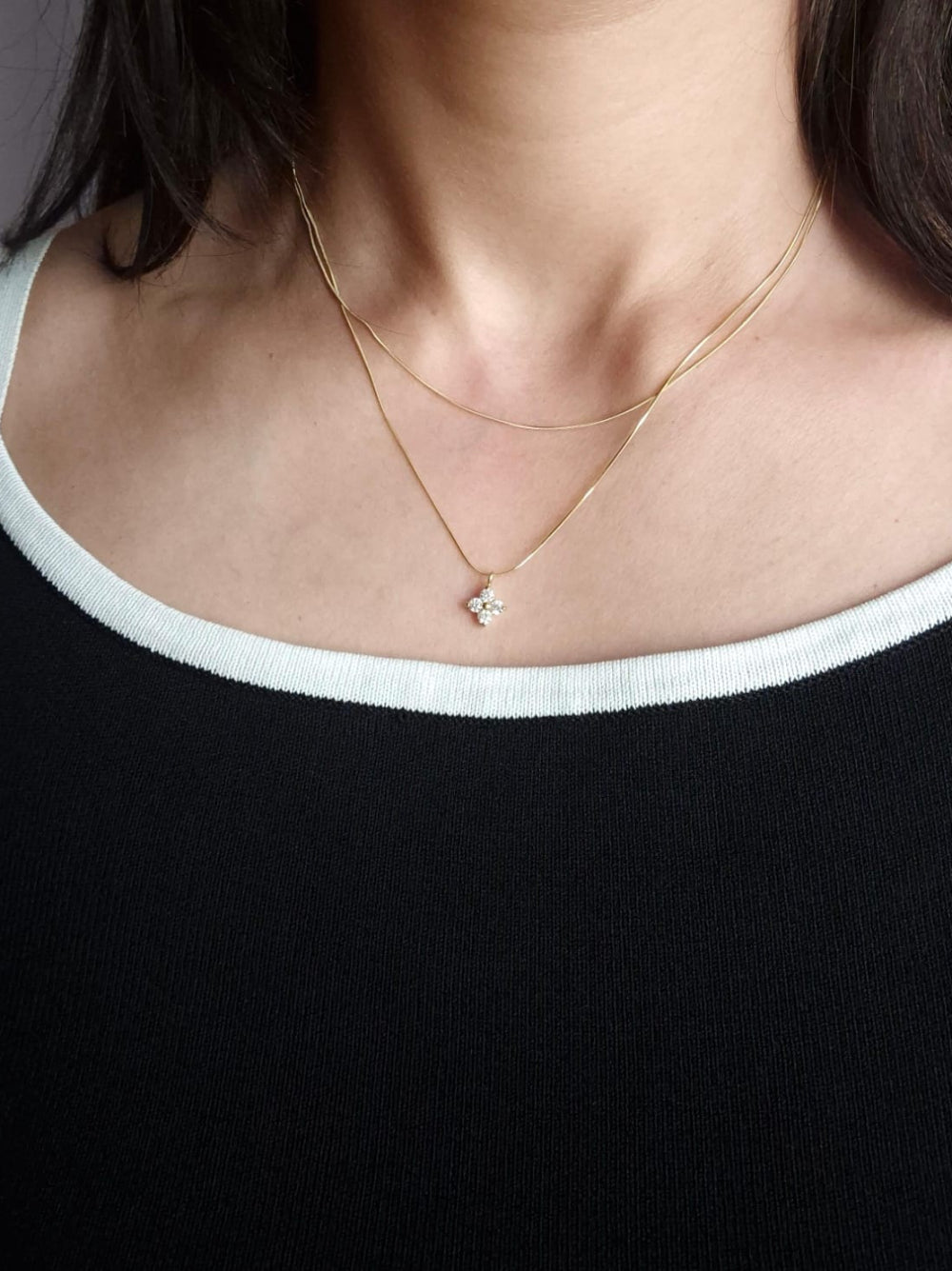 delicate gold necklace with a small pendant.
