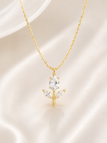 Gold necklace with a leaf-shaped pendant